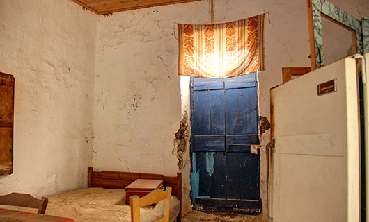 OLD STONE HOUSE WITH AN AGED OLIVE GROVE