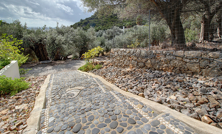 NESTLED IN A LUSH GORGE THAT MEETS THE SEA