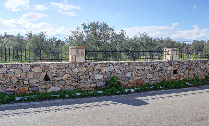 CORNER PLOT SURROUNDED BY STONE WALL